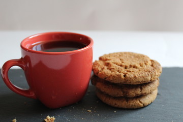 a Cup of tea or coffee with healthy homemade oatmeal cookies on a grey or black grey background with a place to insert