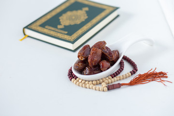 food Ramadan  date Sweets mixed of dried fruits and nuts Glass Tea with a rosary and the Quran, Concept: month fasting culture Muslim and prayer for god, Ramadhan food symbolic eastern Arabian