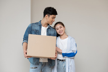 A young asian couple is moving to a new home