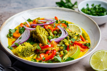 Vegetarian curry with broccoli, pepper, green beans and coconut milk in a bowl.