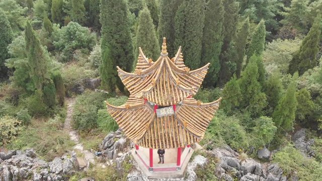 Aerial pan shot above a Chinese pavilion at Xishan Forest Park (Western Hills), near Kunming