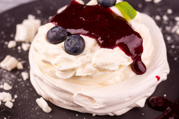 Dessert Pavlova with gentle cream, whipped cream, served with berries and jam