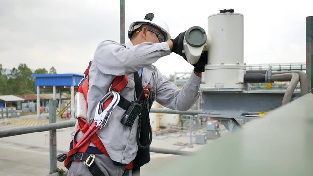 Senior technician to check and repair CCTV Camera on a high structure in the factory