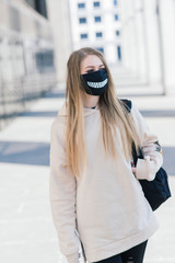 Pretty young woman wearing a protective medical face mask.