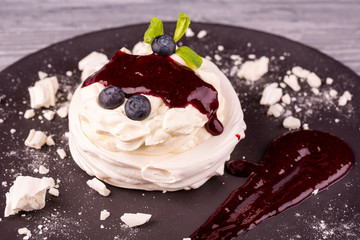 Dessert Pavlova with gentle cream, whipped cream, served with berries and jam