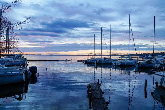 sunrise or sunset on blue water marina boats in lake of biscarrosse landes france