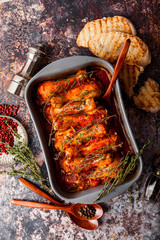 Baked chicken drumsticks on a gray background. Top view