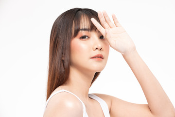 Naklejka premium Beautiful Asian woman looking at camera hand up cover on face smile with clean and fresh skin Happy and cheerful with positive emotion on white background,Beauty Cosmetics and facial treatment Concept