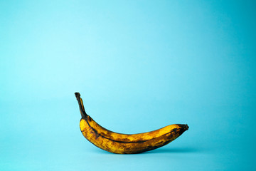 Ripe banana on a blue background. Ripe tropical fruits, food still life concept