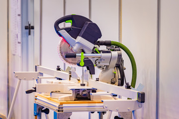 Woodworking. Sawing machine in the carpenter's shop. Wood processing equipment on the table. Manufacture of wooden products. The workplace of the joiner. Carpentry as a hobby.