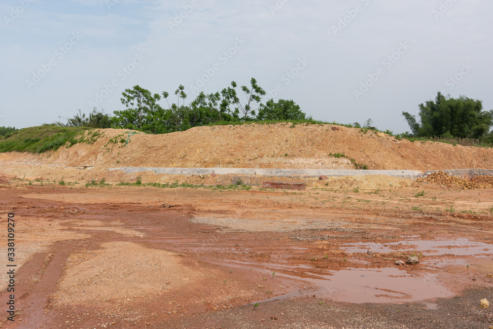 Wall mural Field dirt road construction site