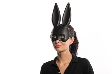 beautiful girl in a black rabbit mask on a white background