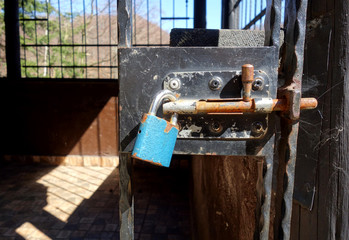 Locked steel gate to the cottage in nature