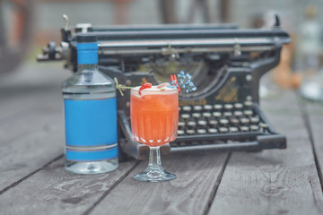 alcoholic cocktail with fruits on an old wooden table