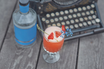 alcoholic cocktail with fruits on an old wooden table