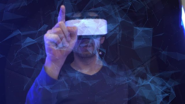 Model young man in glasses of virtual reality on dark background.. Augmented reality, science, future technology concept. VR. Futuristic 3d glasses with virtual projection. Neon light.