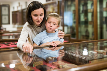Woman and boy exploring artworks in museum
