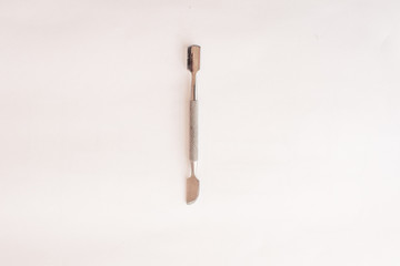 metal pusher for manicure on a white background. Top view. Mock up. Flat lay composition