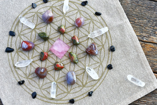 A close up image of a crystal energy healing grid using the flower of life pattern. 