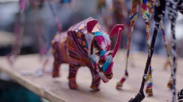 Close up shot of a handmade African curio on sale at a crafts market in the Maboneng district of Johannesburg, South Africa. The curio is a small rhino made from colourful traditional fabric. 