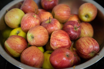 Stainless steel fruit bowl with very beautiful red apples.