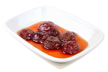 Strawberry jam in the white porcelain plate