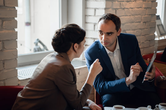 Businessman And Businesswoman Meeting In Coffee Shop - Powered by Adobe
