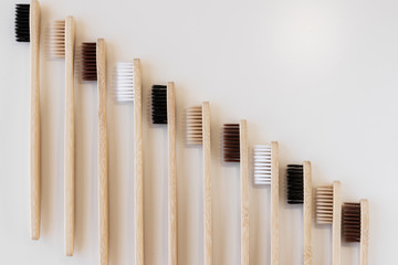 Group of eco bamboo toothbrushes, on white background. Different color. Top view, copy space....