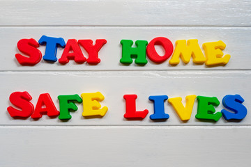 stay home safe lives Sign & Symbol, plastic letter on white wood background