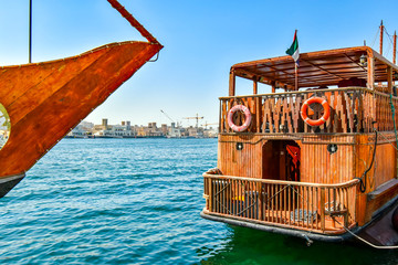 Fototapeta na wymiar Traditional wooden Dhows are moored on the banks of the Creek in Dubai
