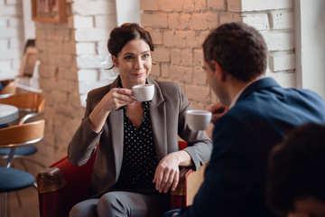Business woman and business man having a meeting in a cafe
