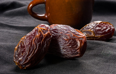 Big luxury dried date fruit on the dark surface, kurma ramadan kareem concept, close up.