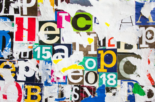 Torn and peeling pieces of dirty paper layers on colorful collage from clippings with letters and numbers texture background.