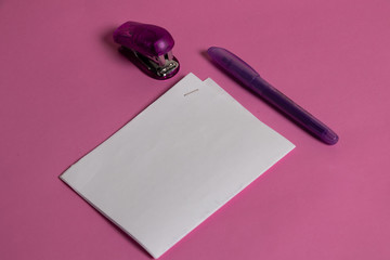 grapadora con elementos de papeleria en colores morado