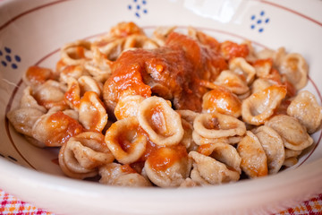 Delicious dish made of fresh pasta orecchietta and meat roll braciola with tomato sauce. Apulia typical food. Italy