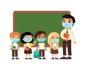 Asian male teacher and international pupils  with protective masks on their faces. Boys and girls dressed in school uniform and male teacher pointing at blackboard cartoon characters. 