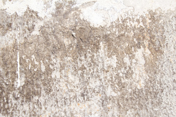 Old dirty weathered stone wall with rough surface texture background.