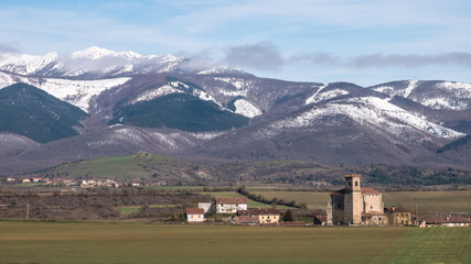Fototapeta na wymiar View of the village of Ordañana and the Aizkorri mountain range, Alavese Plains near Salvatierra, Basque Country, Spain