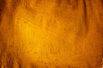 A beautiful Gold paint texture on wall, background - Image. Color paint strokes.