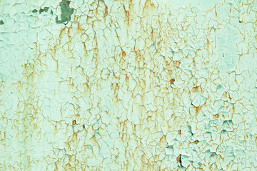 Old green painted metal surface with rust and   corrosion. Green dirty wall with cracked and peeling paint texture background.
