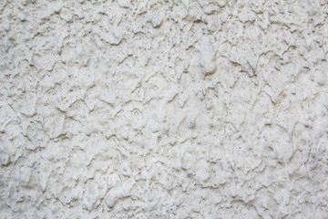 Grey dirty grungy wall with rough surface and streaks texture background.