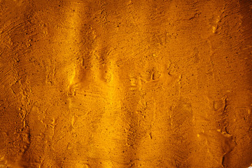 A beautiful Gold paint texture on wall, background - Image. Color paint strokes.