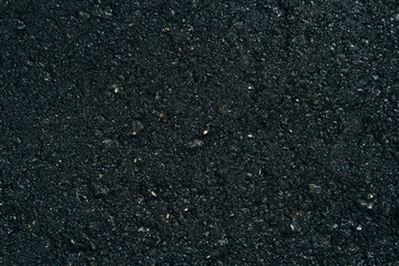 The texture of the black grunge asphalt. The seamless texture of bitumen road asphalt.
