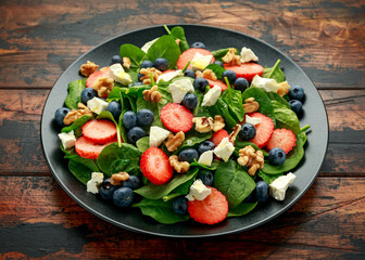 Spinach, Strawberry, blueberry salad with walnut and feta cheese. Summer healthy food