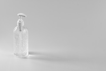 A white clear plastic bottle with transparent hand sanitizer gel isolated on a white background with copy space.