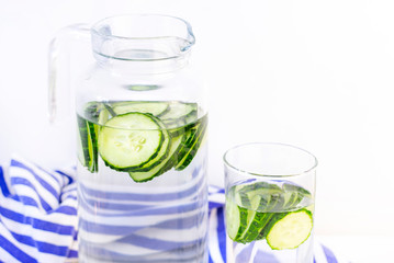 Health care, fitness, healthy eating concept. Fresh cool.cucumber drink with water, cocktail, detox drink, lemonade in a glass jug and a glass.