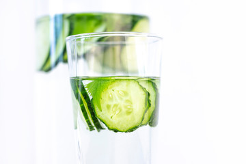 Health care, fitness, healthy eating concept. Fresh cool.cucumber drink with water, cocktail, detox drink, lemonade in a glass jug and a glass.