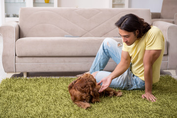 Young man with cocker spaniel dog