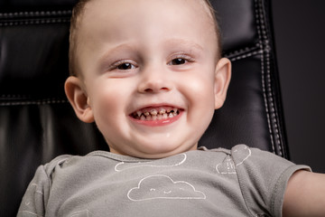 Little boy Smiling and Laughing in the Camera with teeth caries. child showing front teeth with big...