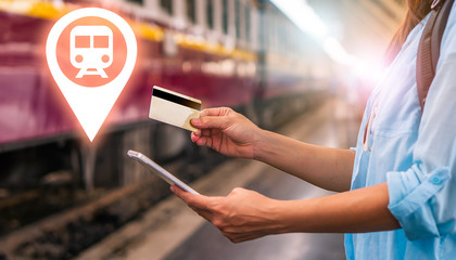 Young smart solo woman tourist travel use mobile phone application plan search information organize trip book reserve transportation bus train hotel flight by internet cashless credit card technology